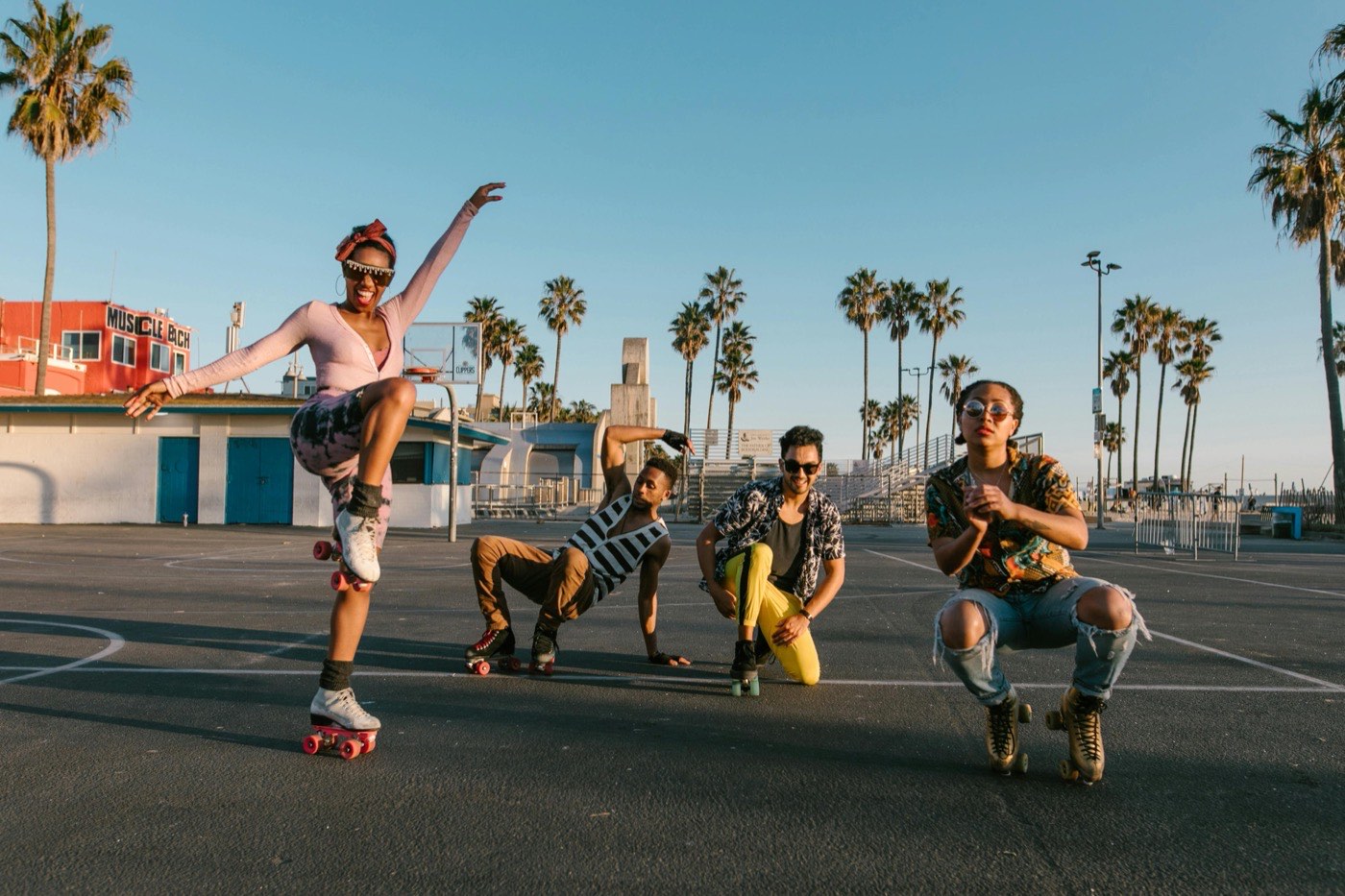 A group roller skating at golden hour under palm trees